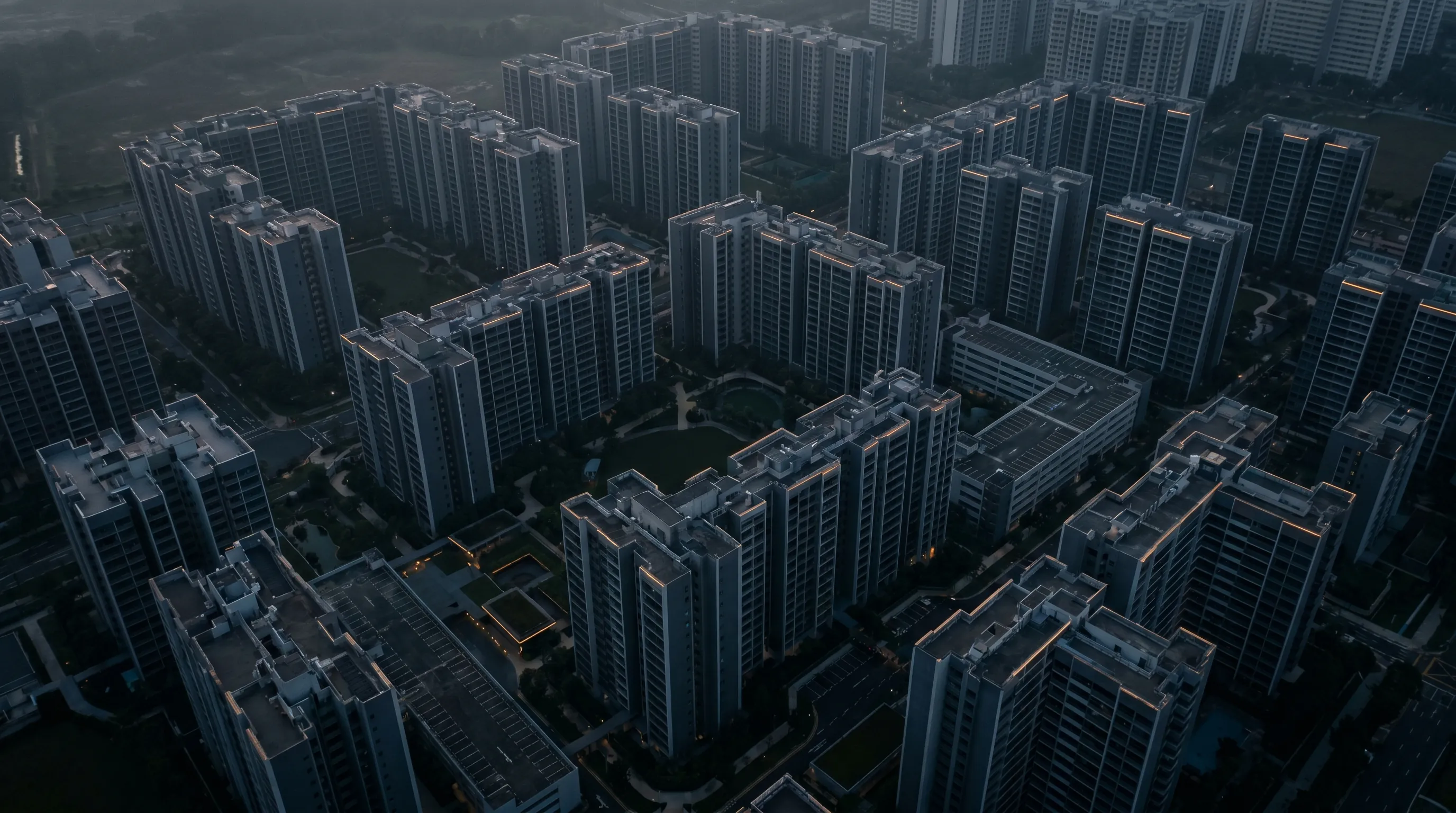 Aerial view of dense newly-completed HDB tower blocks in Punggol Singapore at dawn, conveying the supply surge from 13,480 MOP completions in 2026